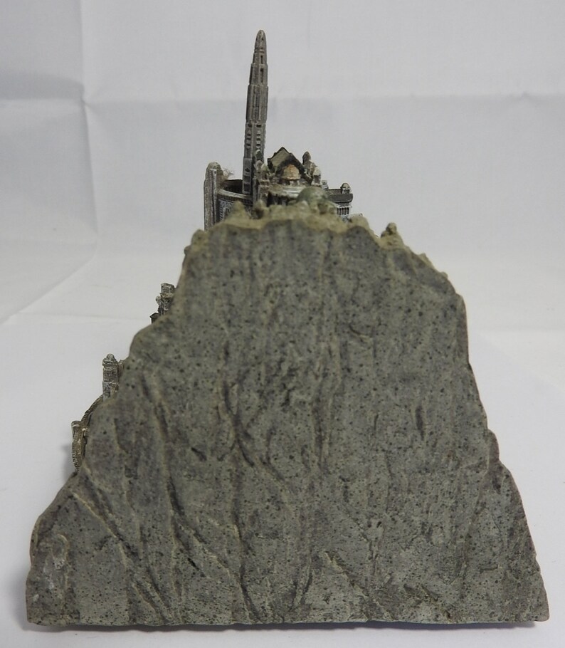 vintage resin small gray ornament paperweight of the town in the rocks with a platform for the plane