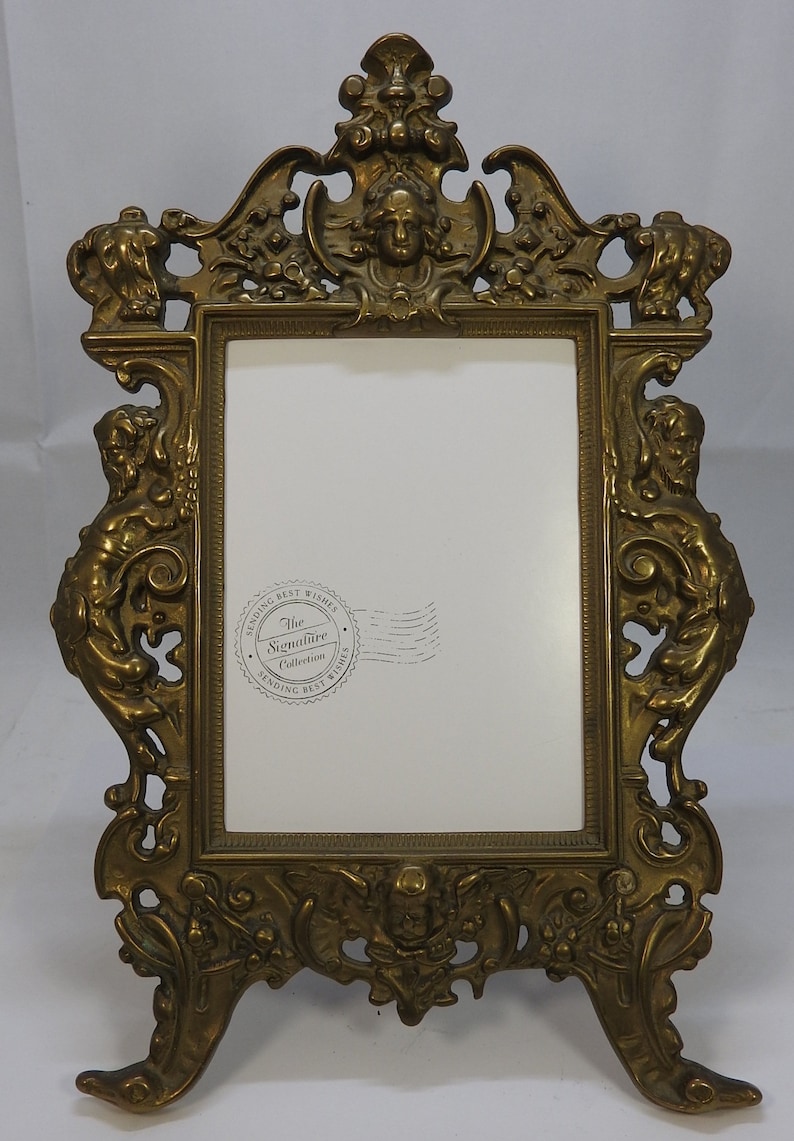 Beautiful vintage brass photo frame with ornate adjustable frame.