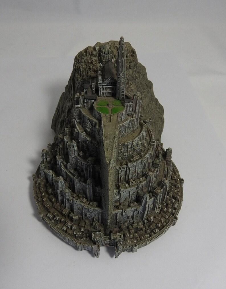 vintage resin small gray ornament paperweight of the town in the rocks with a platform for the plane