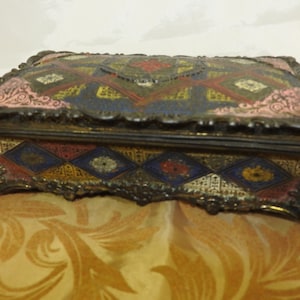 An Enamelled Brass Cigarette Box with Polychrome Decoration, 16.5cm Wide