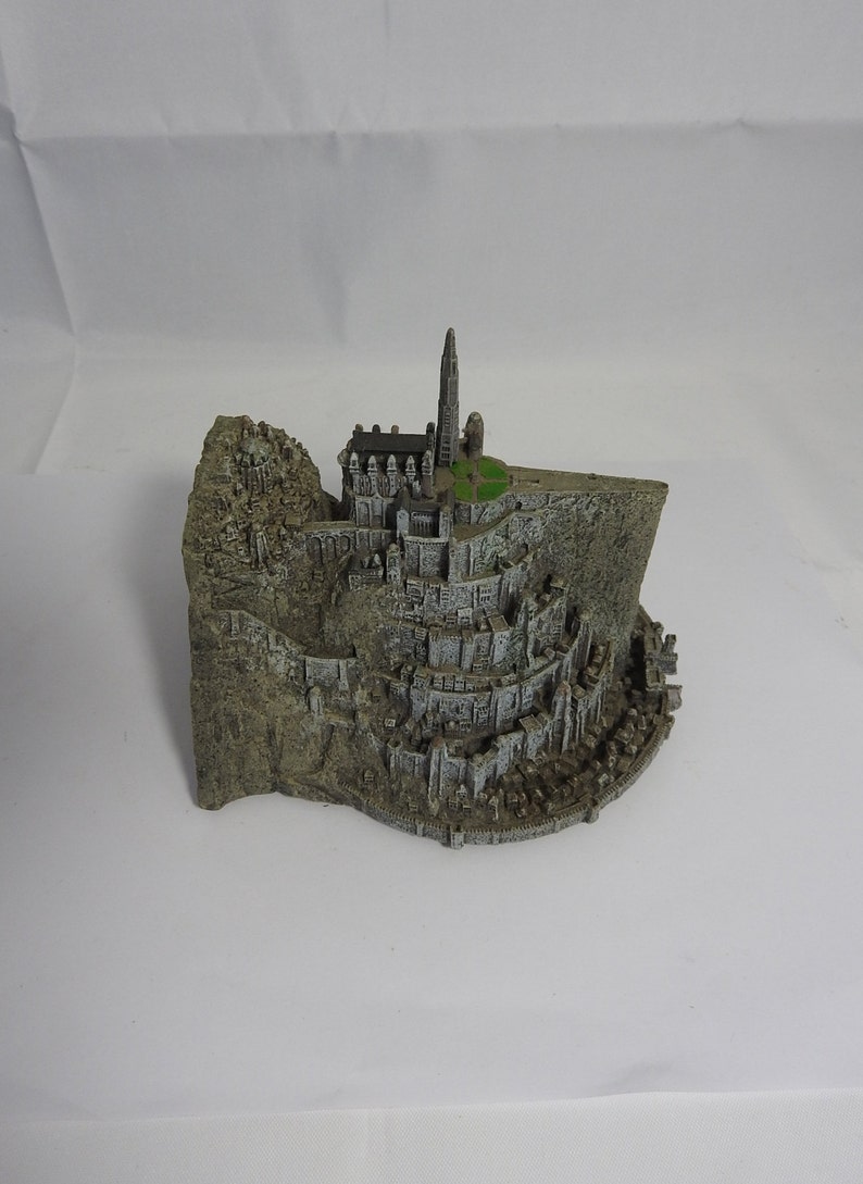vintage resin small gray ornament paperweight of the town in the rocks with a platform for the plane