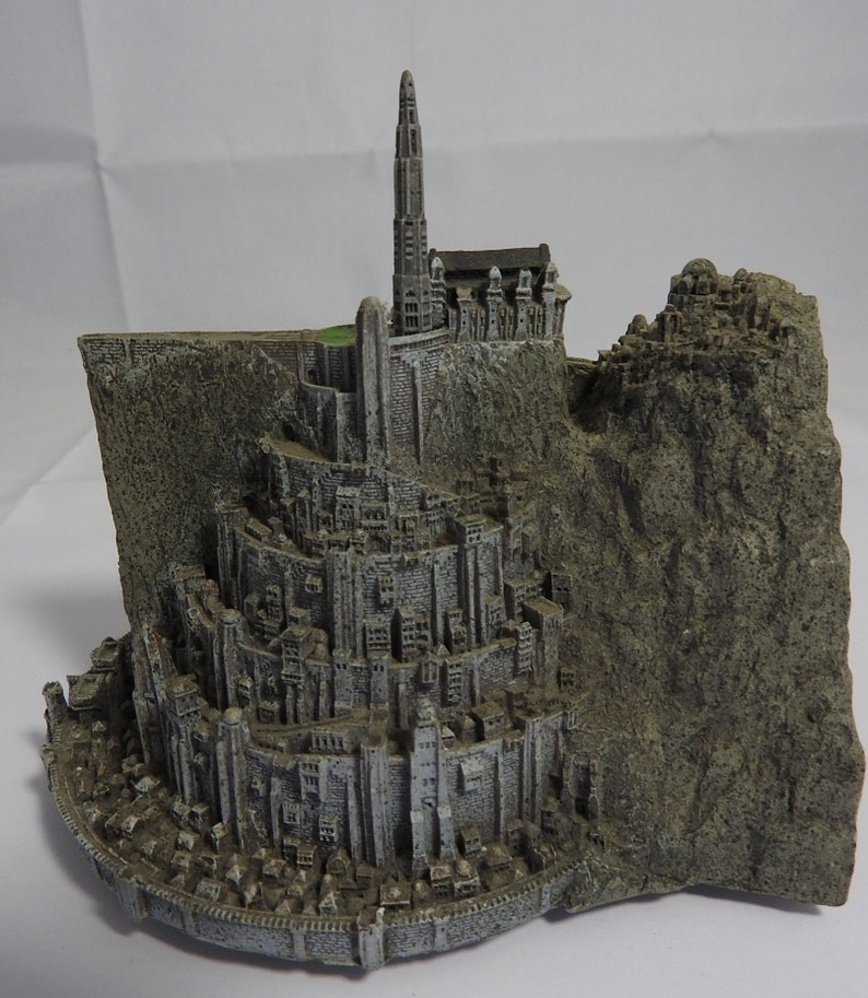 vintage resin small gray ornament paperweight of the town in the rocks with a platform for the plane
