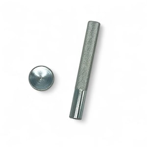 May include: A silver metal tool for setting leather rivets. The tool includes a round punch and a handle.
