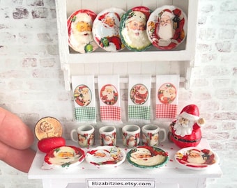 May include: A miniature dollhouse kitchen set with a white hutch, red and white checkered dish towels, and Santa Claus themed plates and mugs.