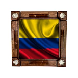 May include: A wooden dominoes game board featuring the flag of Colombia. The board has a dark brown frame with silver-colored cup holders and domino storage slots. The flag design includes yellow, blue, and red horizontal stripes.