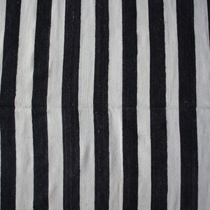 May include: Black and white striped fabric with a woven texture.