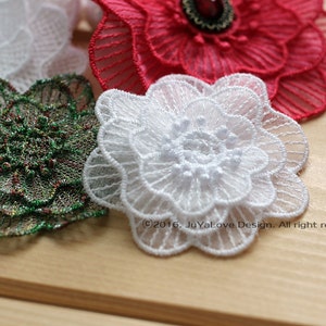 May include: Close-up of several decorative floral appliques in various colors. The appliques are made of delicate lace and include white, red, and green. The white applique is in the foreground. The text "&copy;2016. JuYaLove Design. All right reserved." is visible.