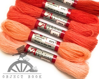 May include: Five skeins of Appleton's crewel wool yarn in shades of orange and peach. Each skein is 25 meters long and made in the UK. The skeins are labeled with the numbers 626, 625, 624, 623, and 622.