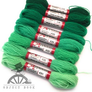 May include: A set of seven skeins of green wool yarn, each skein is labeled with the brand name "Appletons" and a number from 431 to 438. Each skein is 25 meters long and made in the UK from 100% pure English wool.