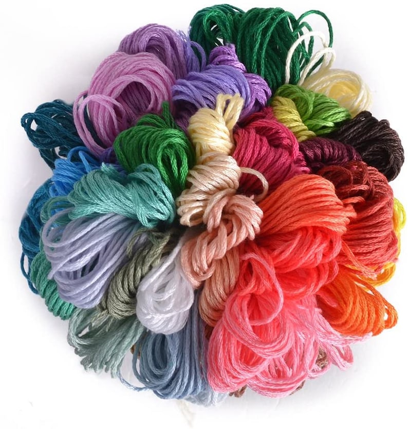 May include: A collection of colorful embroidery floss spools in various shades of green, blue, purple, pink, red, orange, yellow, brown, and white.