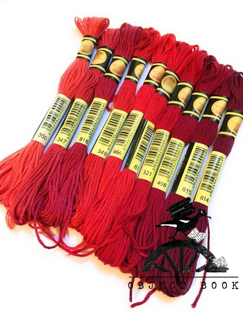 May include: A set of ten red embroidery floss spools with yellow labels and black numbers. The numbers on the spools are 350, 347, 816, 349, 666, 81, 321, 498, 815, and 814.