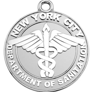 May include: Silver-colored metal charm with a circular design. The charm features the words "NEW YORK CITY DEPARTMENT OF SANITATION" around the edge. In the center is a winged caduceus, a symbol of medicine and healing.