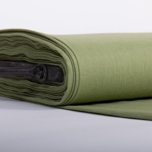 May include: A roll of olive green fabric with a black metal handle. The fabric is folded and rolled up, and the handle is attached to the roll.