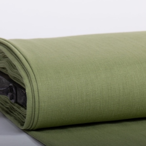 May include: A roll of green linen fabric, tightly wound and secured with a metal handle.