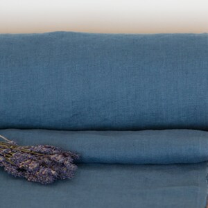 May include: A roll of blue linen fabric with a bundle of dried lavender flowers on top.