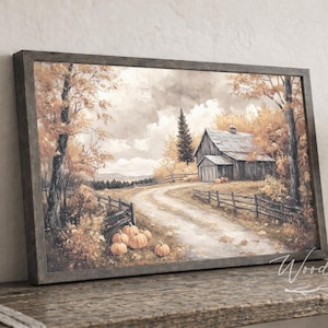 May include: Framed watercolor print of a rural autumn scene. The artwork depicts a dirt road leading to a barn, surrounded by trees with orange and yellow leaves. Several pumpkins are placed near the road. The frame is dark gray. The text "Woodland Shanty" is in the bottom right corner.