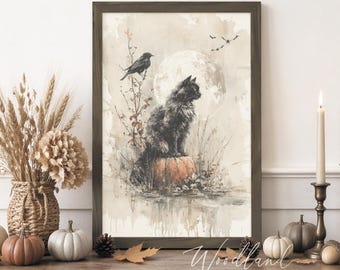 May include: A framed watercolor print depicts a black cat perched on a pumpkin, with a full moon in the background. A crow sits on a branch. The scene is set in a muted color palette, evoking a Halloween or autumn theme. The print is displayed on a rustic wooden table with decorative pumpkins and candles.