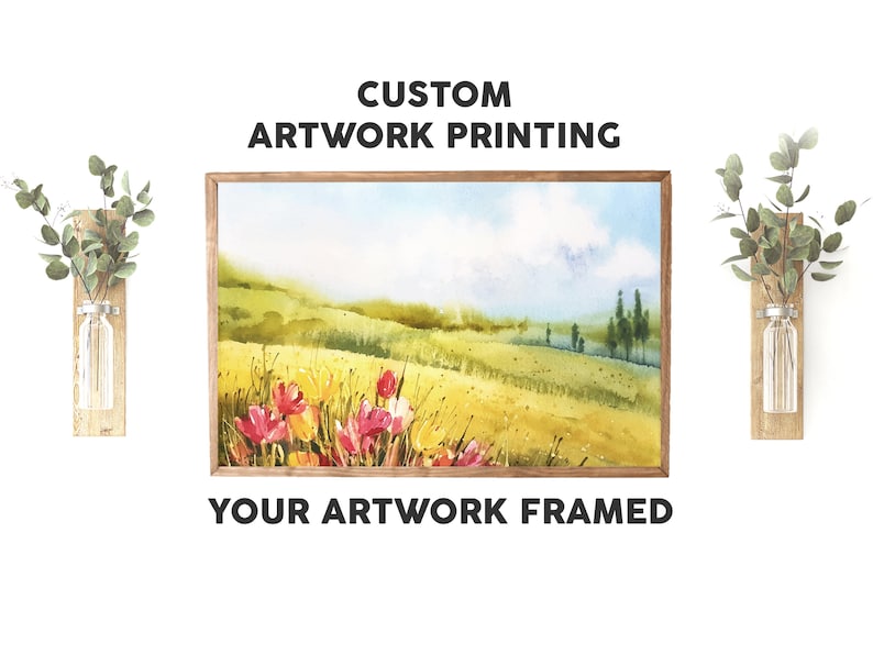 May include: A framed watercolour painting of a field of wildflowers with a blue sky and white clouds in the background. The text "CUSTOM ARTWORK PRINTING" and "YOUR ARTWORK FRAMED" is displayed above and below the painting.