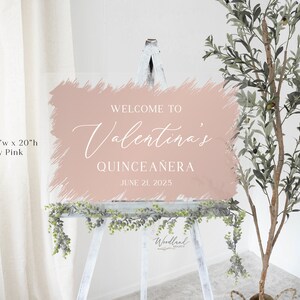May include: A dusty pink welcome sign with a brushstroke effect, announcing "Welcome to Valentina's Quincea&ntilde;era June 21, 2025". The sign is 30 inches wide by 20 inches high.