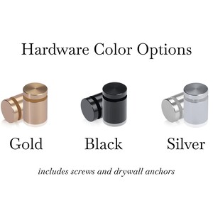 May include: Image showing hardware color options: gold, black, and silver. Each color option is represented by two cylindrical standoffs. The text includes "Hardware Color Options" and "includes screws and drywall anchors."