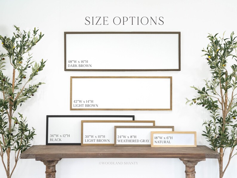May include: A display of rectangular framed signs in various sizes and colors, including dark brown, light brown, black, weathered gray, and natural. The signs are labeled with size options, such as 48"W x 16"H, and the text "SIZE OPTIONS" is at the top.