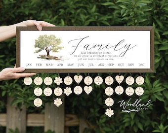 May include: A wooden family calendar with a brown frame. The calendar features a watercolor tree illustration and the word "Family" in script. Includes wooden tags for birthdays and anniversaries. The text reads "Like branches on a tree, we all grow in different directions, yet our roots remain as one."