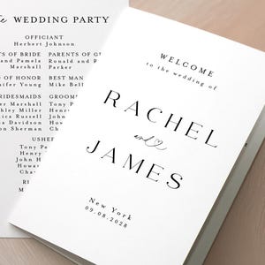 May include: White wedding programs with black text. The programs are open, displaying the ceremony details, wedding party, and the names "Rachel and James" with the wedding date and location. The background is a soft, neutral colour.
