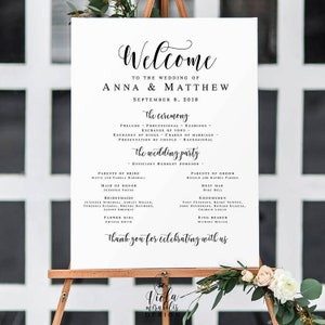 Puede incluir: Un cartel de bienvenida de boda blanco con texto negro. El cartel dice "Bienvenido a la boda de Anna & Matthew 8 de septiembre de 2018". El cartel también enumera los detalles de la ceremonia de boda y la fiesta de boda.