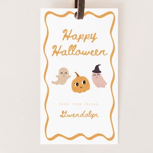 May include: A white Halloween gift tag with a brown string. The tag features a decorative orange border and the words "Happy Halloween" in orange script. Below are illustrations of a ghost, pumpkin, and witch ghost.
