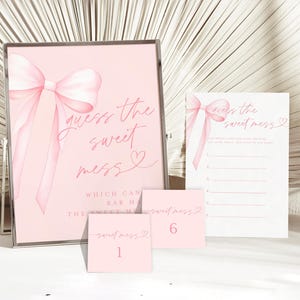 May include: Pink and white printable game cards with a pink bow and the text "Guess the Sweet Mess" for a bridal shower or wedding.