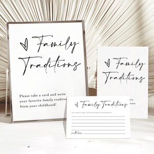 May include: A white sign with black text that reads "Family Traditions".  Below the text is a smaller text that reads "Please take a card and write your favorite family tradition from your childhood!"  There are two white cards with black text that reads "Family Traditions".  One card has a line for writing and the other card has a space for writing.