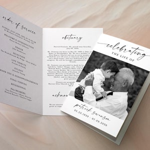May include: A black and white photograph of a man holding a young child. The photo is on a white card with the text "celebrating the life of Patrick Swanson 05.23.1939 - 07.09.2030".