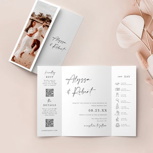 May include: A tri-fold wedding invitation with a white background and black text. The invitation features a photo of the couple on the front, the couple's names, the date and time of the wedding, and the location of the reception. The back of the invitation includes a detailed schedule of the wedding day.
