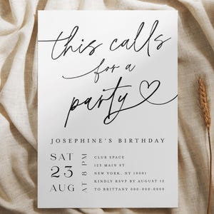 Minimalist printed birthday party invitation card featuring elegant black calligraphy text “this calls for a party” with a heart accent, designed for an adult birthday celebration. The card is displayed on a soft neutral fabric background with wheat accents, emphasizing its modern, classy, and printed-on-cardstock quality. Perfect for birthday parties, anniversaries, and adult gatherings.