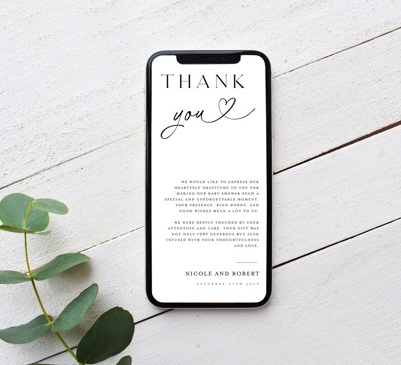 May include: A white thank you card with black text on a smartphone screen. The text reads "THANK you" with a heart symbol. The card also includes a message expressing gratitude for attending a baby shower. The message reads "We would like to express our heartfelt gratitude to you for making our baby shower such a special and unforgettable moment. Your presence, kind words, and good wishes mean a lot to us. We were deeply touched by your attention and care. Your gift was not only very generous but also infused with your thoughtfulness and love. Nicole and Robert"