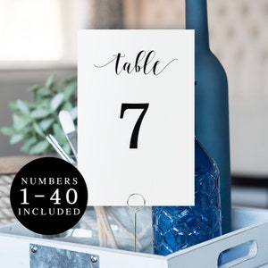 May include: White table number card with black calligraphy that says "table" and the number "7".  Numbers 1-40 are included.