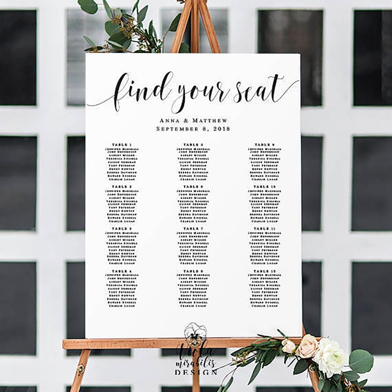 May include: A white wedding seating chart with black text. The chart is titled "Find Your Seat" with the names Anna & Matthew and the date September 8, 2018. The chart lists tables with guest names.