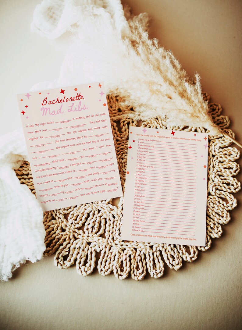 May include: A pink and white printable bachelorette party game called "Mad Libs". The game includes a story with blank spaces to be filled in with words from a list of categories. The categories include nouns, verbs, adjectives, and more.