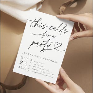 May include: A white invitation card with black script that reads "this calls for a party". The card includes details for Josephine's birthday, including the date, time, and location. The card is held by hands.