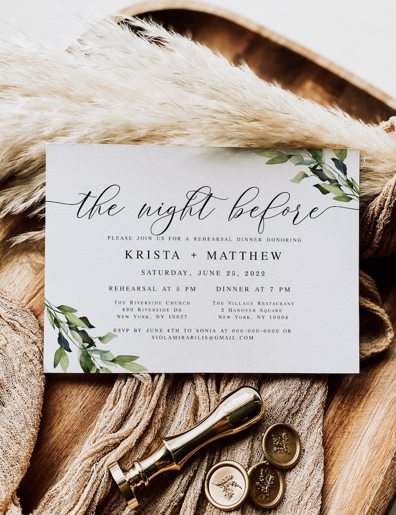 May include: A white invitation card with green foliage and calligraphy text that reads "the night before". The invitation is for a rehearsal dinner honoring Krista and Matthew on Saturday, June 25, 2022. The invitation includes the time and location for the rehearsal and dinner.