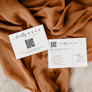 May include: White RSVP card with a black and white QR code, the text "Kindly RSVP by June 20, 20XX" and the text "Please scan to RSVP on our wedding website www.ourweddingwebsite.com".
