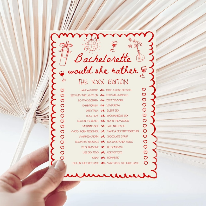 May include: A red and white bachelorette party game card titled "Bachelorette would she rather THE XXX EDITION." The card features a decorative border and illustrations of a disco ball, wine glasses, and other party-themed graphics.