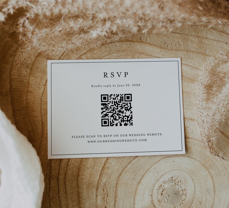 May include: A white RSVP card with black text and a black QR code. The text reads "RSVP" and "Kindly reply by June 20, 20XX". Below the QR code is the text "PLEASE SCAN TO RSVP ON OUR WEDDING WEBSITE WWW.OURWEDDINGWEBSITE.COM".