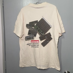 May include: A white t-shirt with a graphic of computer memory chips and the text "DATARAM...gigabyte-class memory for workstations and network servers."