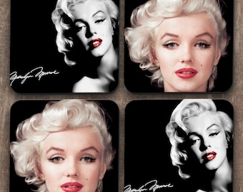 May include: Set of four black and white square coasters featuring a portrait of Marilyn Monroe with her signature in white. Each coaster has a different pose of Marilyn Monroe.