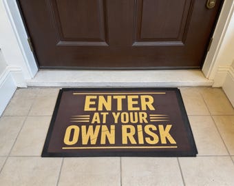 Enter At Your Own Risk 60x40cm Welcome Mat – Funny Floor Mat – Novelty Housewarming Gift – Non Slip Rubber Backing - For Indoor