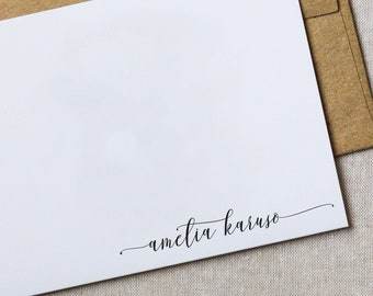 May include: White stationery card with a handwritten signature that reads "amelia karuso" in black ink.