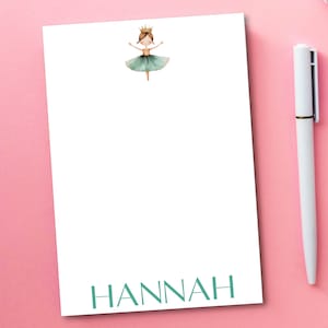 May include: White notepad with a green ballerina illustration and the name "HANNAH" printed in green at the bottom.