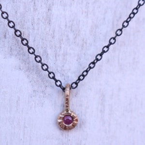Mixed metal charm pendant 14 k gold ruby