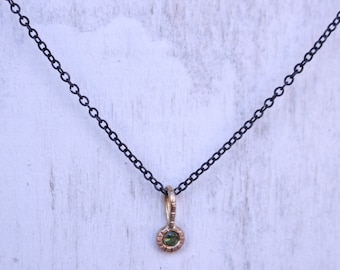 Mixed metal charm pendant 14 k gold tsavorit